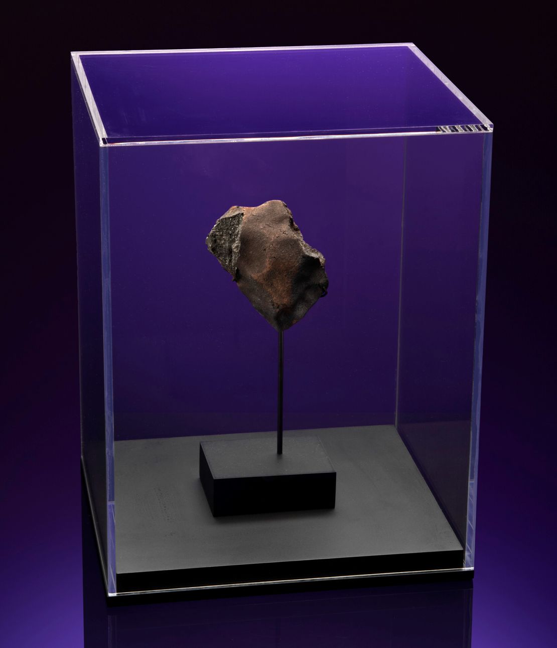 A meteorite named 'Aguas Zarcas (CM2) Meteorite' that crashed through the roof of a doghouse in the city of Aguas Zarcas, Central Costa Rica, on April 23, 2019, is on view at Christie's online-only auction: 'Deep Impact: Martian Lunar and Other Rare Meteorites', in February 2022. 