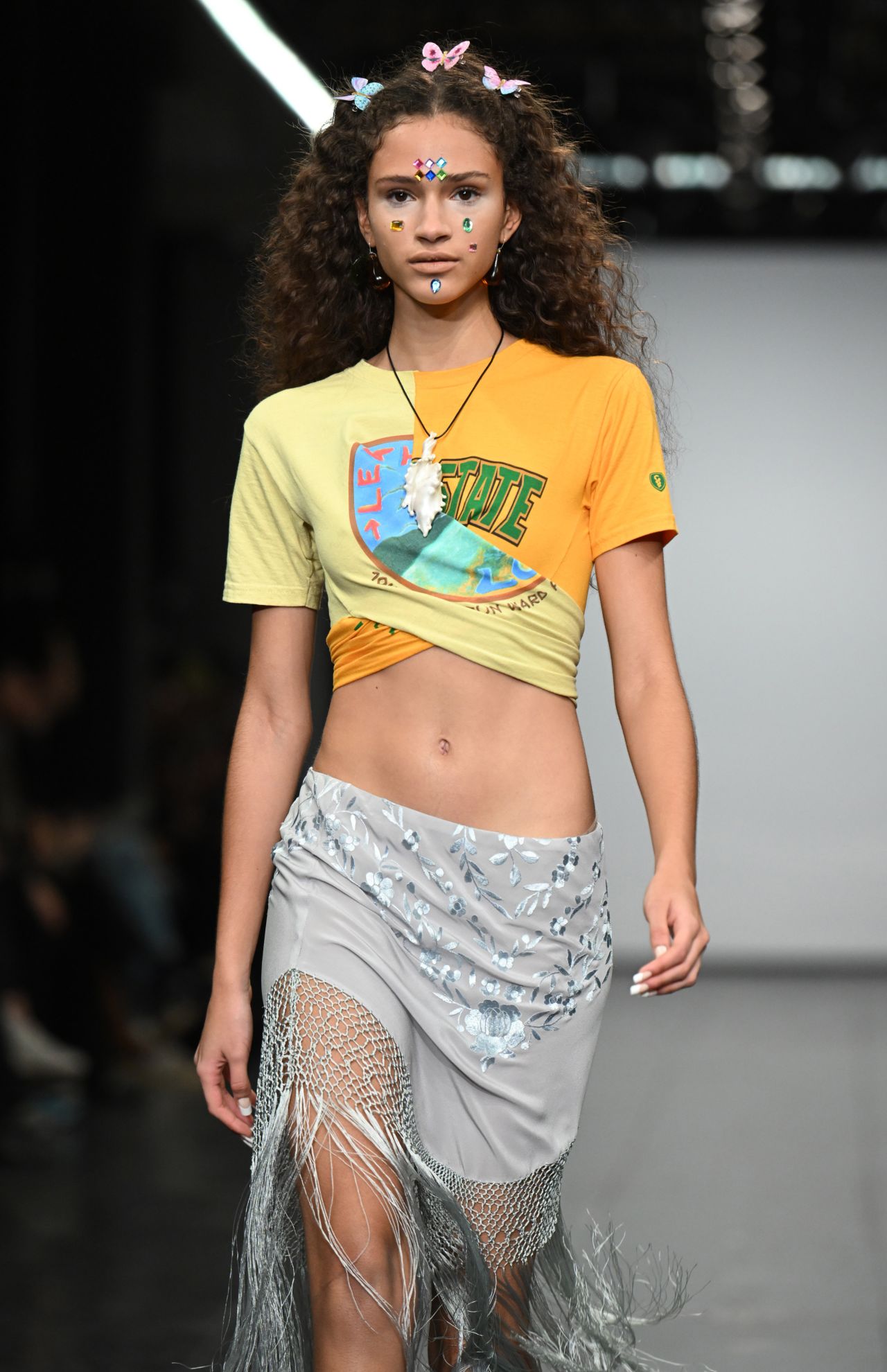 Butterfly clips, beaded sarongs and face-gems gave the Conner Ives show a '90s feel.
