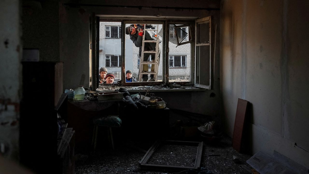 A damaged house is worked on after shelling near the Ukrainian front-line city of Novoluhanske on February 22.
