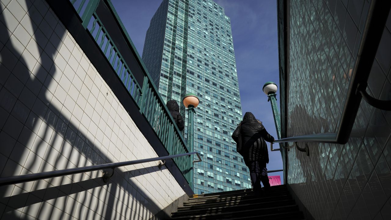 A woman exits the Court Square subway station as Citibank building stands in the background in Long Island City, Queens, NY, in February 2019.