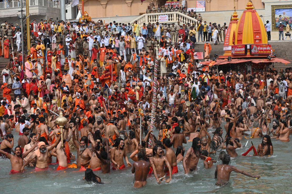 Hindu holy men take a dip in the Ganges River during the religious Kumbh Mela festival, in Haridwar on April 12, 2021.