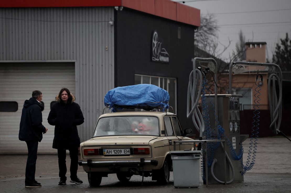 Local residents are seen refueling at a gas station in Mariupol, eastern Ukraine.