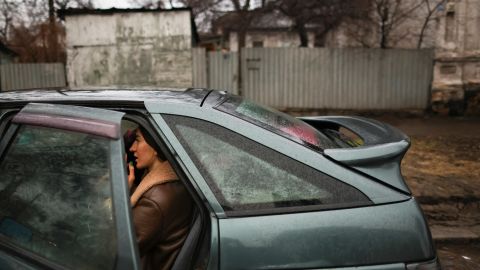 A local resident sits in a car as they pack to leave Mariupol, eastern Ukraine.