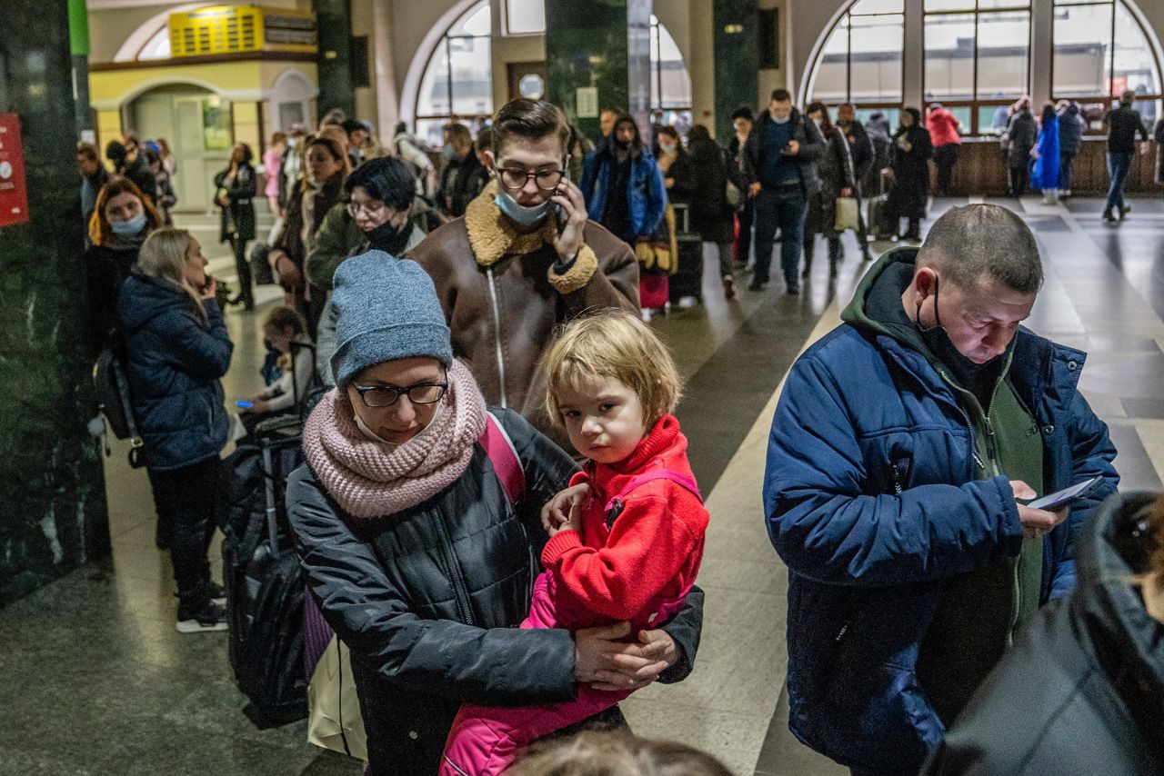 People wait in line to buy train tickets at the central station in Kyiv on February 