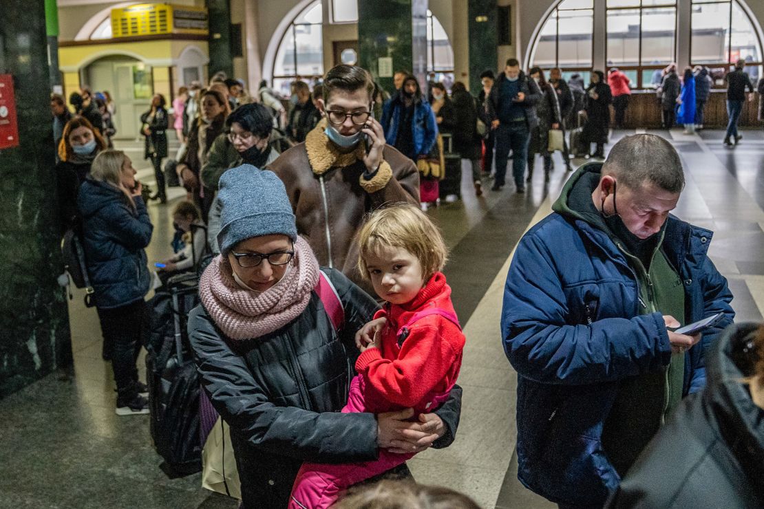 People wait in line to buy train tickets at the central train station in Kyiv.