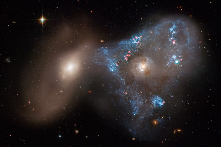 An unusual triangle shape formed by two galaxies crashing together in a cosmic tug-of-war has been captured in a new image taken by NASA's Hubble Space Telescope. The head-on collision between the two galaxies fueled a star-forming frenzy, creating "the oddball triangle of newly minted stars."
