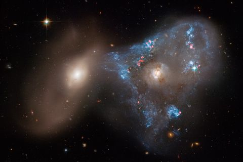 An unusual triangle shape formed by two galaxies crashing together in a cosmic tug-of-war has been captured in a new image taken by NASA's Hubble Space Telescope. The head-on collision between the two galaxies fueled a star-forming frenzy, creating 