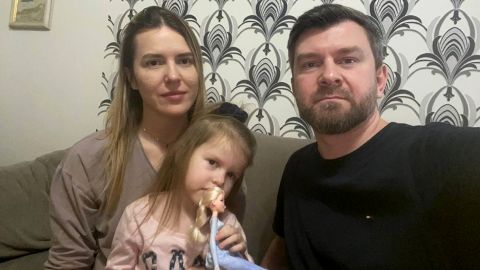 Yana and Sergii Lysenko sit with their 3-year-old daughter.