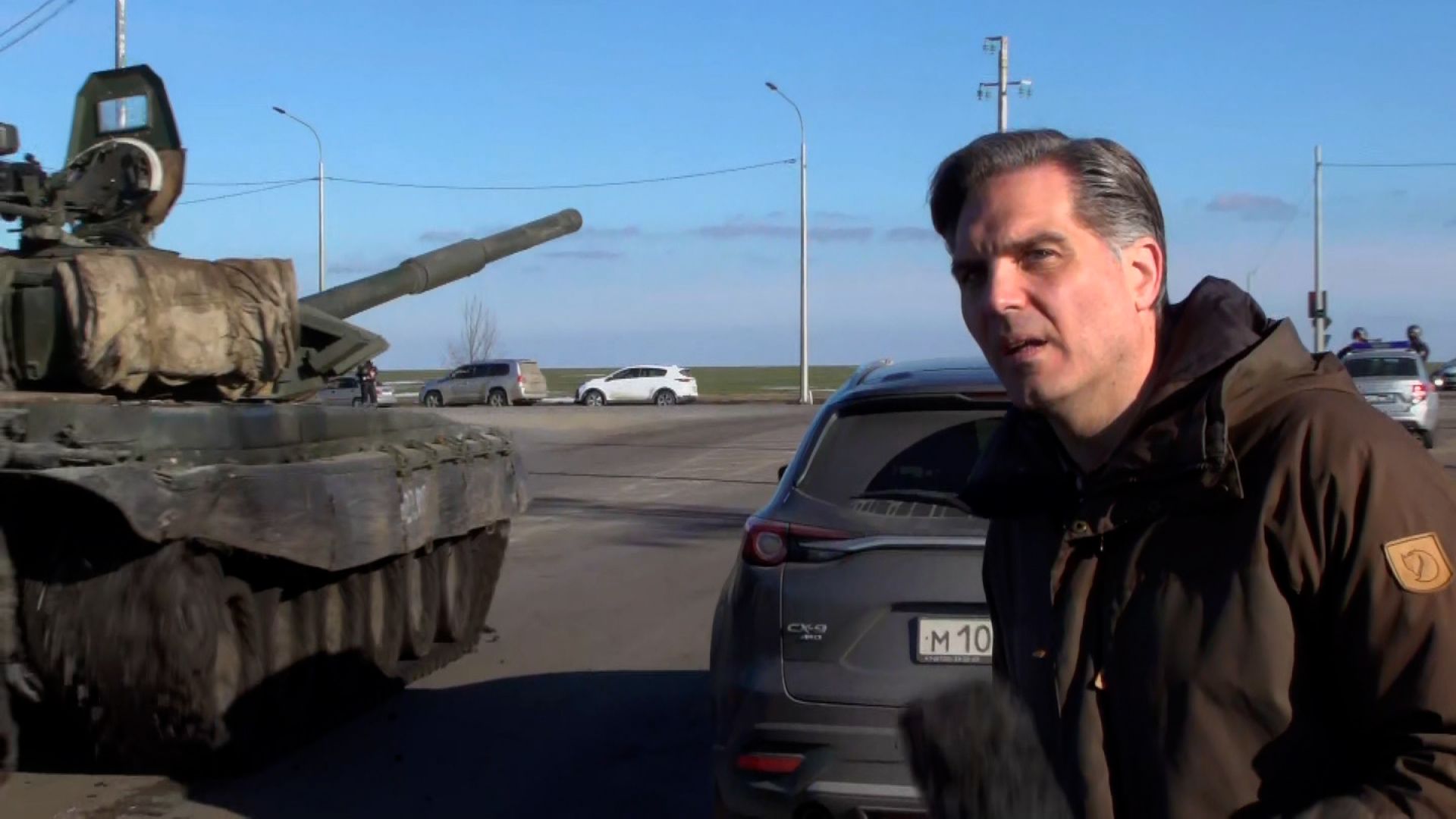 Russian tanks roll past CNN reporter as they appear to head toward Ukraine