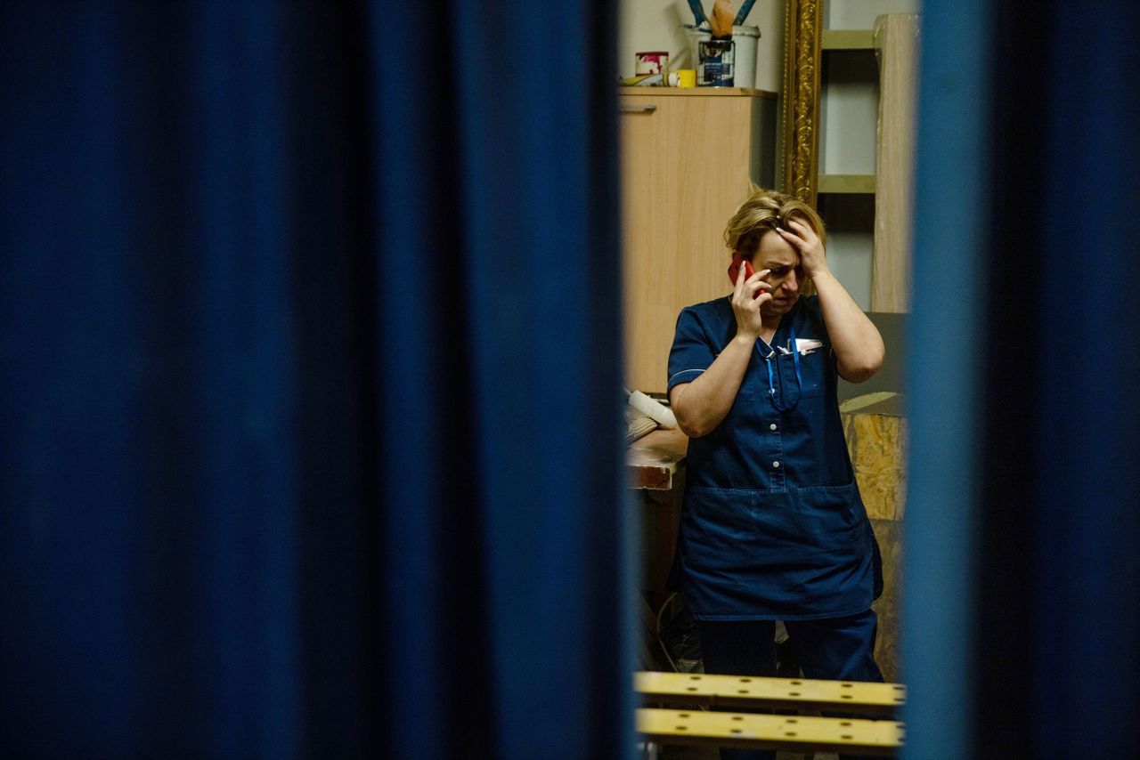 A staff member of a Kyiv hotel talks on the phone on February 24.