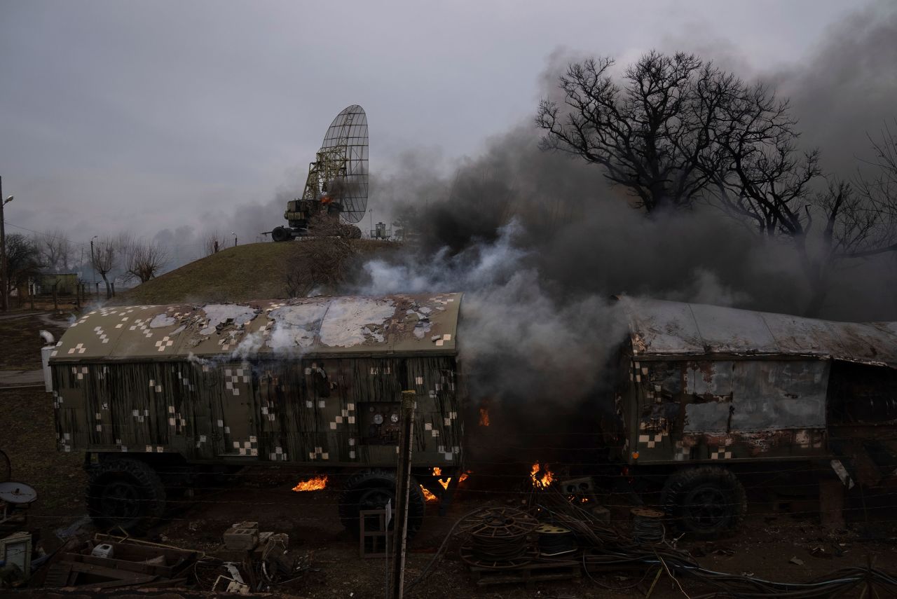 Smoke rises from an air defense base after an apparent Russian strike in Mariupol on February 24. A CNN team in Mariupol reported hearing <a href=