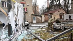 Police and security personnel inspect the remains of a shell in a street in Kyiv on February 24, 2022. - Russian President Vladimir Putin announced a military operation in Ukraine on Thursday with explosions heard soon after across the country and its foreign minister warning a "full-scale invasion" was underway. (Photo by Sergei Supinsky / AFP) (Photo by SERGEI SUPINSKY/AFP via Getty Images)