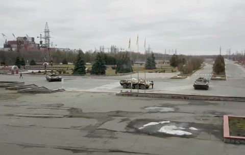 Russian military vehicles are seen at the Chernobyl power plant near Pripyat, Ukraine, on February 24. Russian forces <a href=