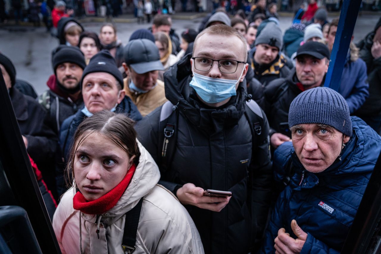 People in Kyiv try to board a bus to travel west toward Poland on February 24.