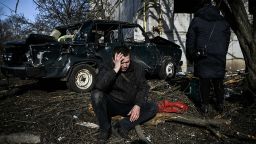 TOPSHOT - A man sits outside his destroyed building after bombings on the eastern Ukraine town of Chuguiv on February 24, 2022, as Russian armed forces are trying to invade Ukraine from several directions, using rocket systems and helicopters to attack Ukrainian position in the south, the border guard service said. - Russia's ground forces today crossed into Ukraine from several directions, Ukraine's border guard service said, hours after President Vladimir Putin announced the launch of a major offensive. Russian tanks and other heavy equipment crossed the frontier in several northern regions, as well as from the Kremlin-annexed peninsula of Crimea in the south, the agency said. (Photo by Aris Messinis / AFP) (Photo by ARIS MESSINIS/AFP via Getty Images)