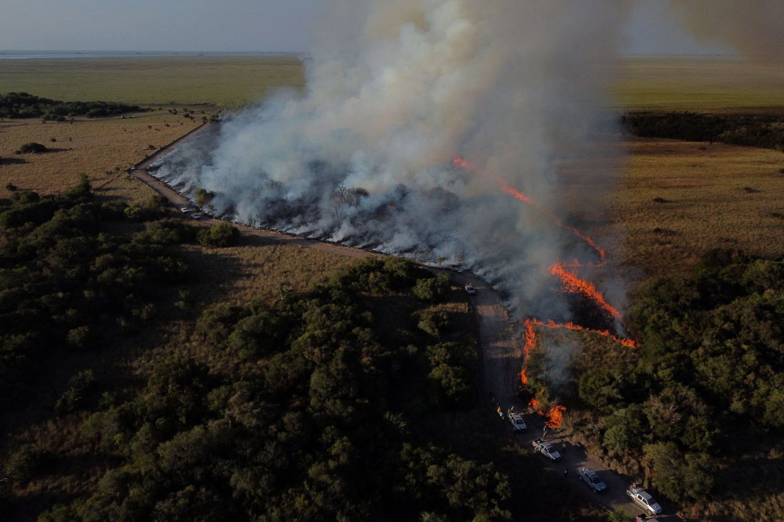 Firefighters burn a field in an attempt to fight wildfires near Ibera National Park in Corrientes, Argentina, on Tuesday, February 22. <a href="index.php?page=&url=https%3A%2F%2Fwww.cnn.com%2F2022%2F02%2F23%2Fworld%2Fwildfire-increase-climate-change-unep-report%2Findex.html" target="_blank">Burning parts of the land on purpose</a> has historically prevented larger, more destructive fires. Indigenous people have been applying this preventative method, known as controlled or prescribed burns, for thousands of years.
