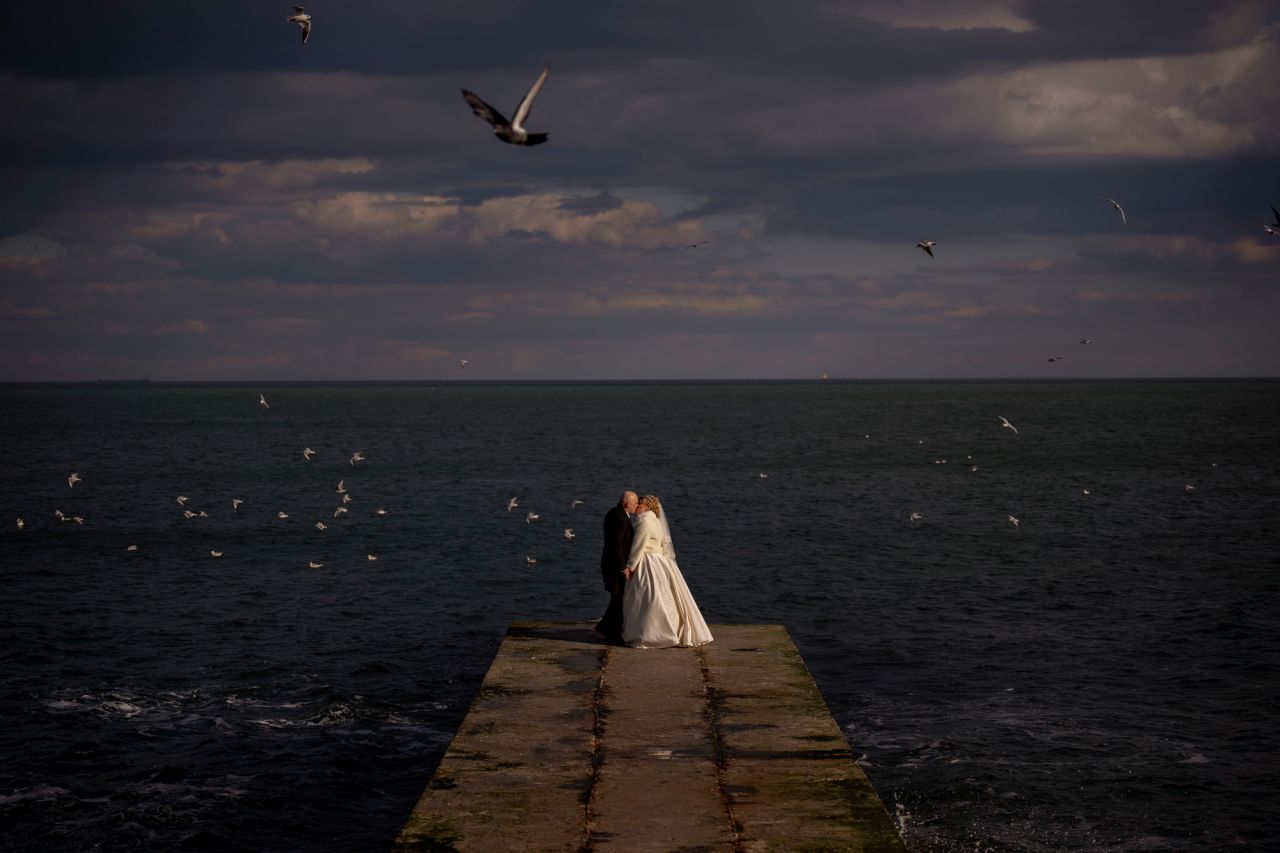 Newlyweds Alexandra Tabashnenko and Pavel Tabashnenko kiss after getting married in Odessa, Ukraine, on Friday, February 18.