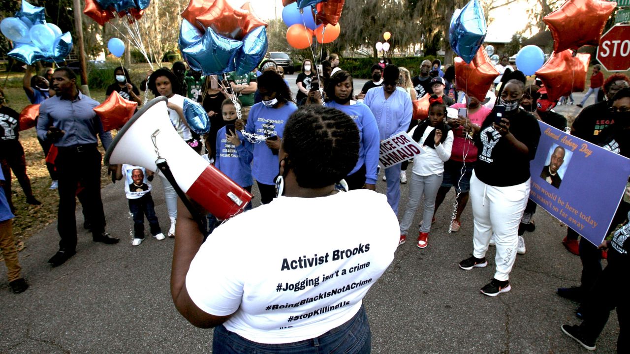 Thea Brooks, Arbery's aunt, talks to marchers at the intersection of Holmes Road and Satilla Drive where Arbery was shot and killed two years ago in Brunswick, on February 23, 2022.