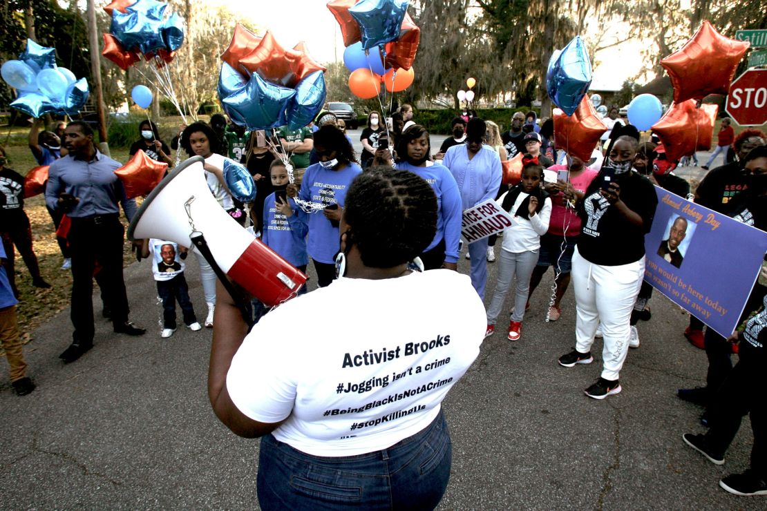 Thea Brooks, Arbery's aunt, talks to marchers at the intersection of Holmes Road and Satilla Drive where Arbery was shot and killed two years ago in Brunswick, on February 23, 2022. 