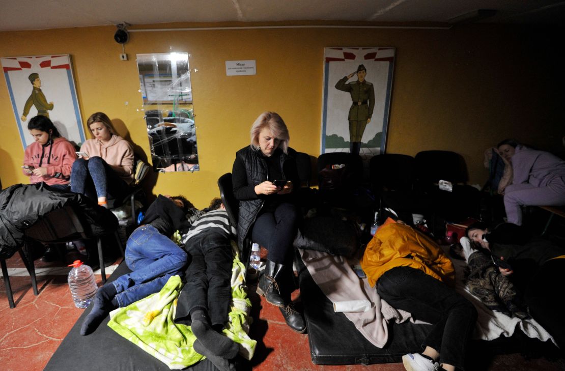 People hide in a bomb shelter in Kyiv in the early hours of February 25.