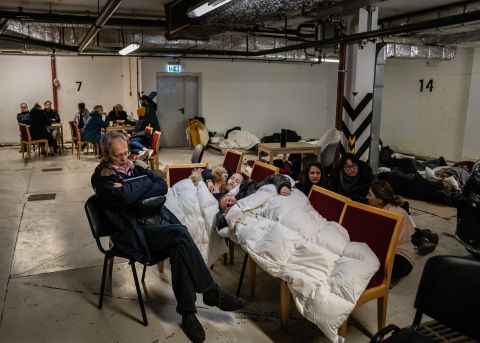 Kyiv residents take shelter in an underground parking garage on February 25.