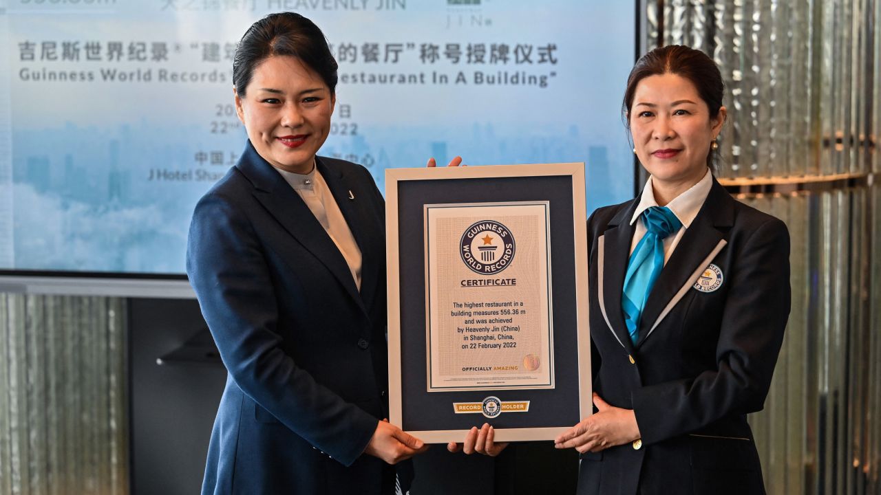 General manager of the J Hotel Shanghai Tower, Jenny Zhang (left) receives the Guinness World Record certificate for highest restaurant in a building. 