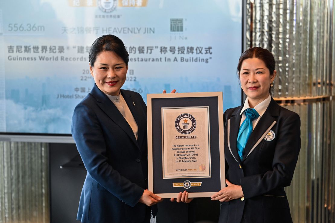 General manager of the J Hotel Shanghai Tower, Jenny Zhang (left) receives the Guinness World Record certificate for highest restaurant in a building. 