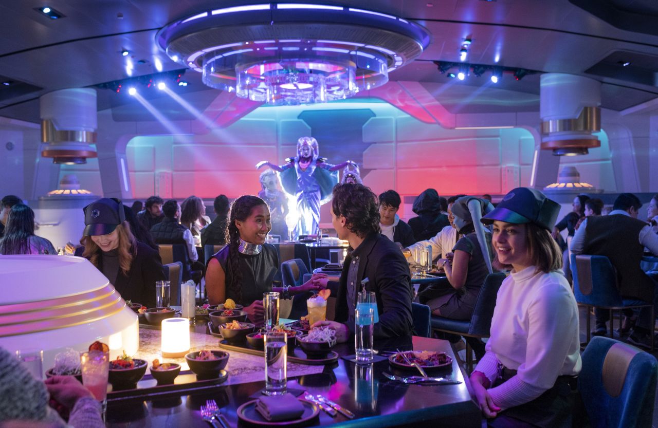 Halcyon passengers enjoy a meal and performance by Gaya in the Crown of Corellia Dining Room.