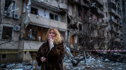 Natali Sevriukova reacts next to her house following a rocket attack on Kyiv on Friday, February 25, 2022.