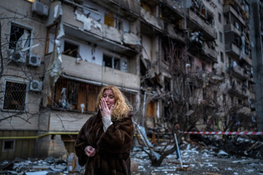 Natali Sevriukova reacts next to her house following a rocket attack on Kyiv on Friday, February 25, 2022.
