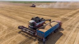 An Acros combine harvester, manufactured by Rostselmash OJSC, dumps harvested wheat into a truck during the summer harvest on a farm in this aerial photograph taken in Tersky village, near Stavropol, Russia, on Friday, July 9, 2021. Farmers from Kansas to Kyiv are gearing up to collect abundant wheat crops in coming weeks, helping ease a global grain shortfall thats fueled a surge in prices. Photographer: Andrey Rudakov/Bloomberg via Getty Images