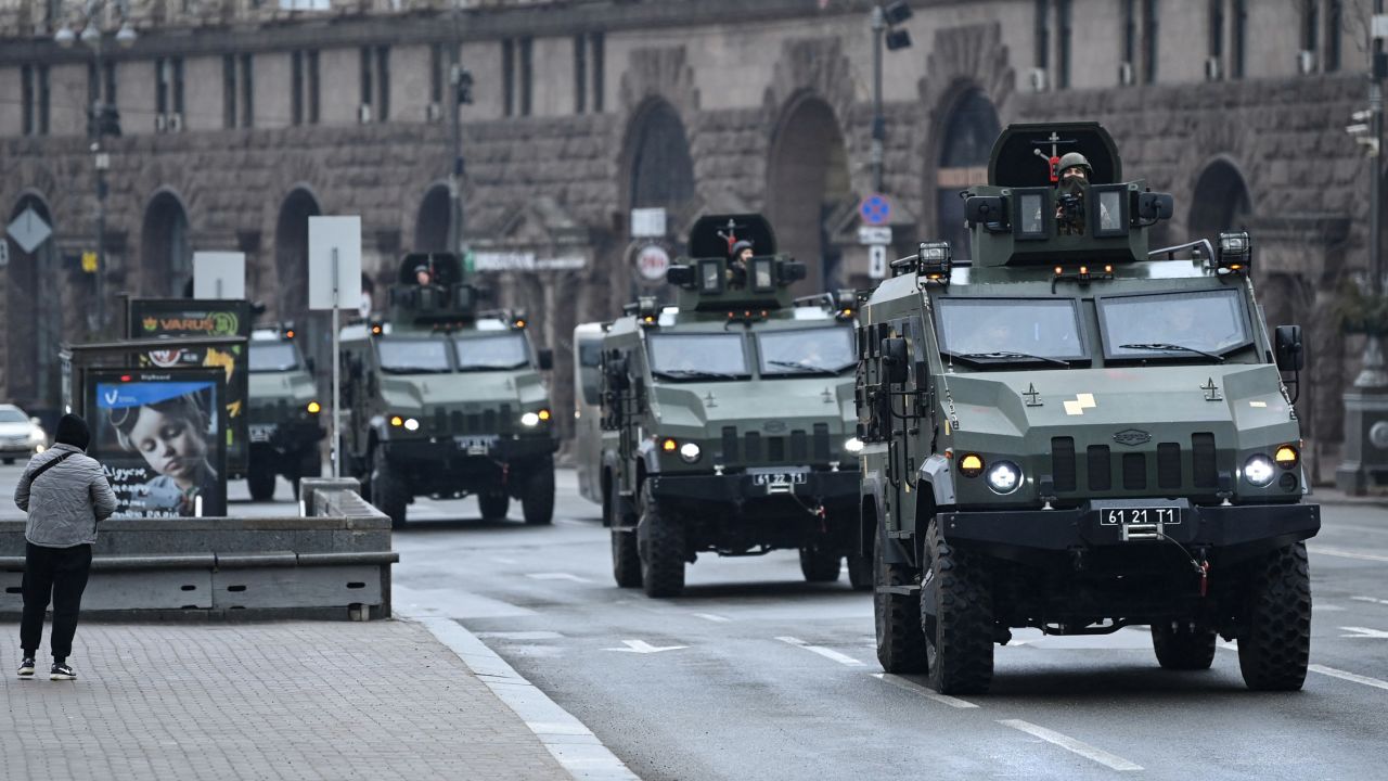 Ukrainian military vehicles move past Independence Square in central Kyiv on February 24, 2022.