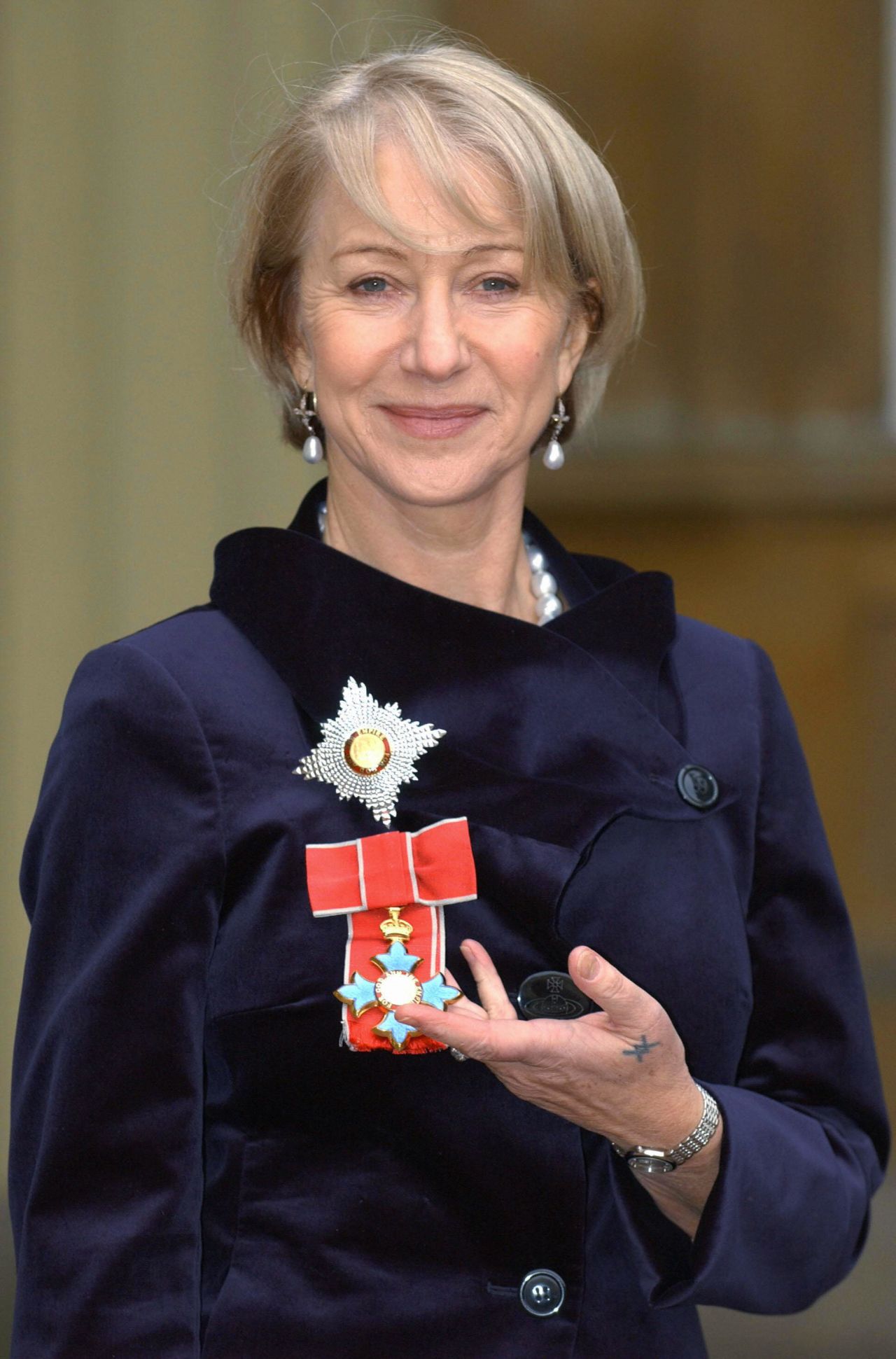 On December 5, 2003, Mirren was invested as a Dame from the Prince of Wales during a ceremony at Buckingham Palace.