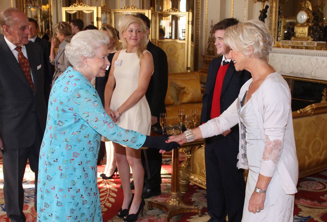 Mirren shakes hands with Queen Elizabeth II during a performing arts reception at Buckingham Palace in 2011.