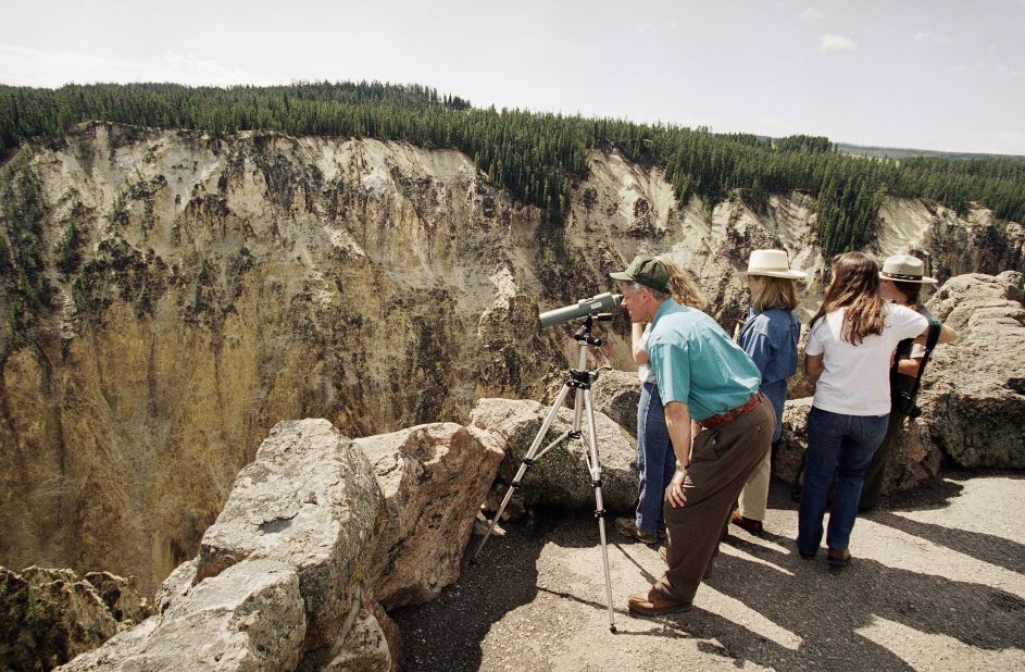 <strong>First family visit:</strong> President Bill Clinton takes a look through a telescope at the park on August 25, 1995, with his wife Hillary, daughter Chelsea and her friend Rebecca Kolsky.