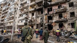 People look at a damaged residential building at Koshytsa Street, a suburb of the Ukrainian capital Kyiv, where a military shell allegedly hit, on February 25, 2022. -

Photograph: Timothy Fadek / Redux
