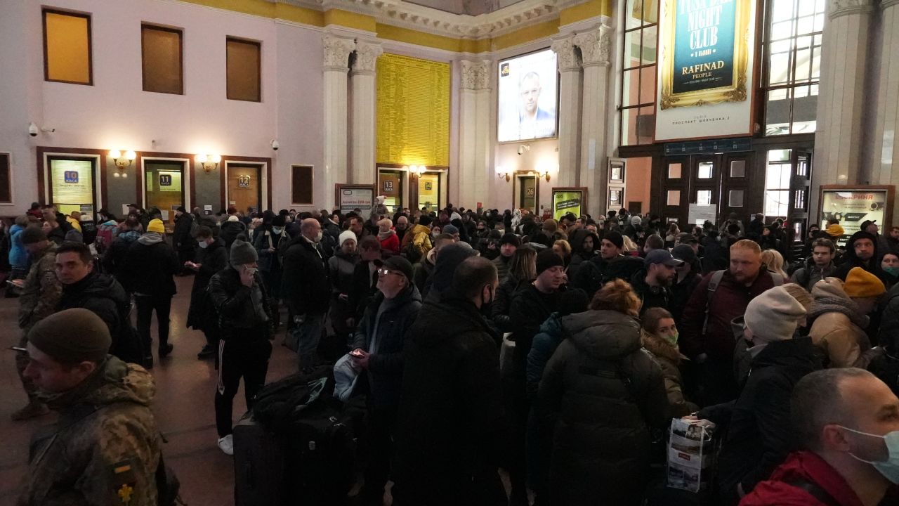 Crowds of displaced people disembark at Lviv station.