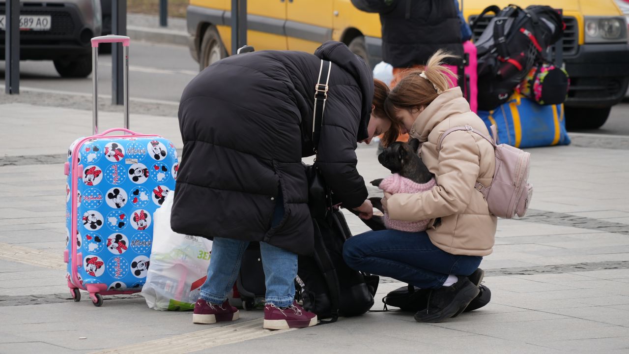 Families gathering their belongings outside the station.