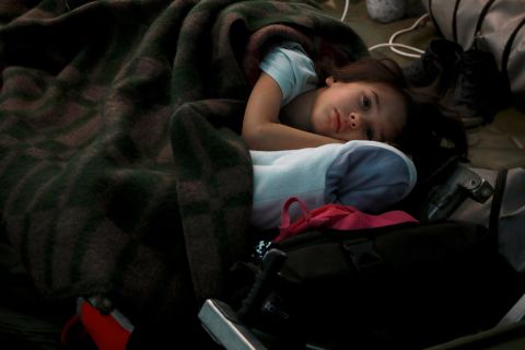 A child from Ukraine sleeps in a tent at a humanitarian center in Palanca, Moldova, on February 25.
