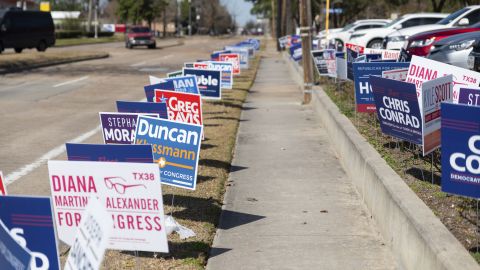 Campaign signs line the sidewalks on February 18, 2022, outside of a polling location in Spring Branch, Texas, just outside of Houston. 