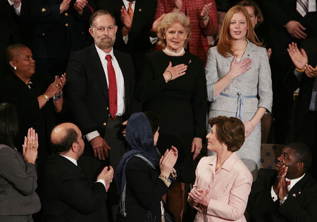 Family members of Staff Sgt. Dan Clay, a U.S. Marine killed in Iraq in 2005, are applauded as they place their hands over their hearts while acknowleging U.S. President George W. Bush during his State of the Union speech on January 31, 2006. Pictured are (left to right) Clay's father, Clarence "Bud" Clay Jr,. mother Sara Jo Clay, and wife Lisa Clay. First lady Laura Bush applauds. 