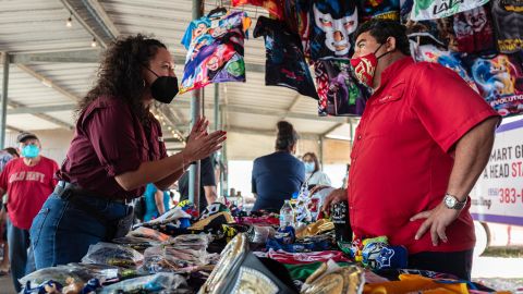 Michelle Vallejo, Democratic candidate for Texas' 15th Congressional District, speaks with a vendor at the Pulga Los Portales, a flea market in Alton, Texas.