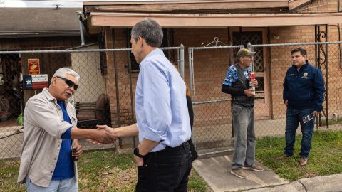 Former Rep. Beto O'Rourke (center left), now running for governor, and Rep. Vicente Gonzalez (right) speak with Robert Lopez (far left) and James Roussett while canvassing a neighborhood in Brownsville.