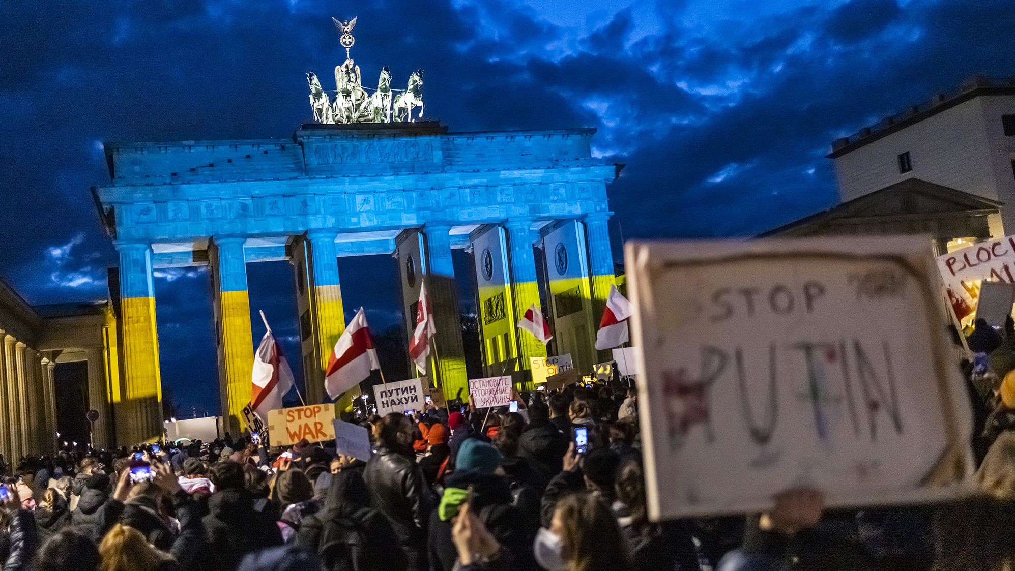 People protest in front of the Brandenburg Gate in Berlin on February 24.
