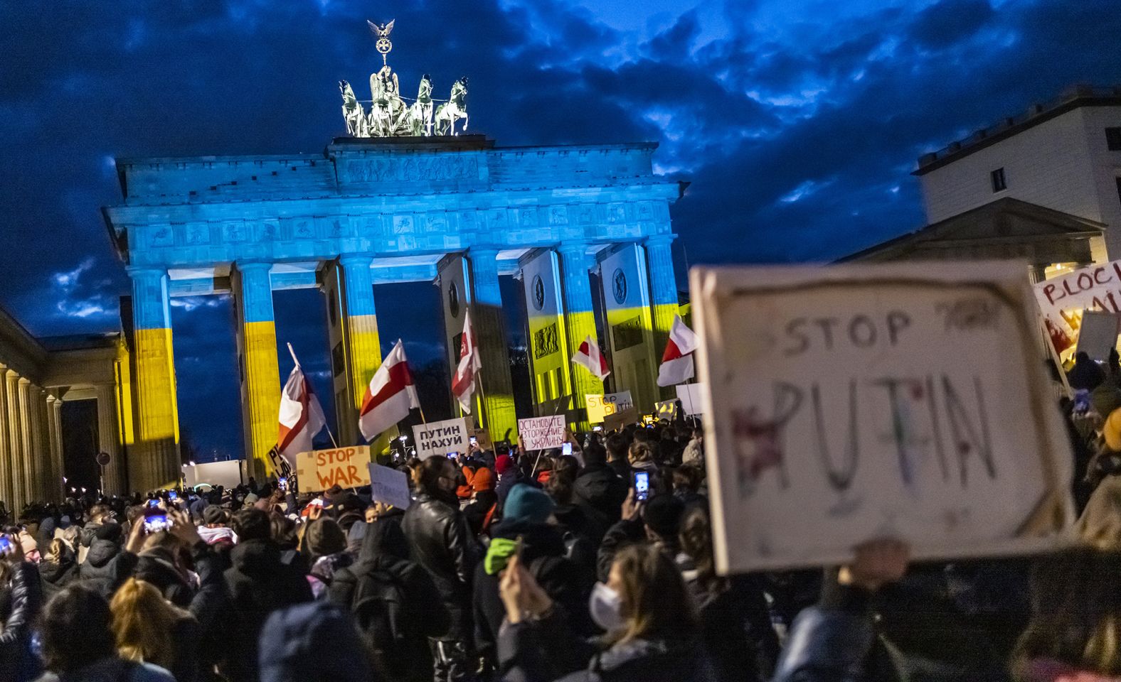 People protest in front of the Brandenburg Gate in Berlin on February 24.