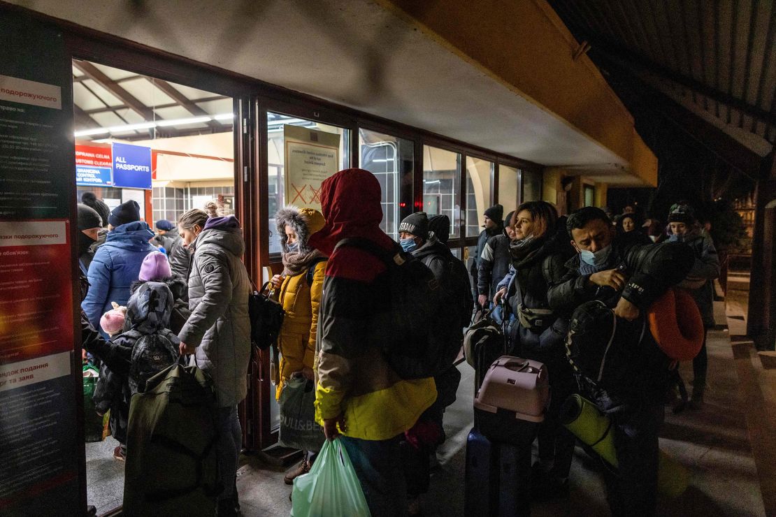 Ukrainian citizens arrive at a border control checkpoint between Poland and Ukraine, during the early hours of February 26.