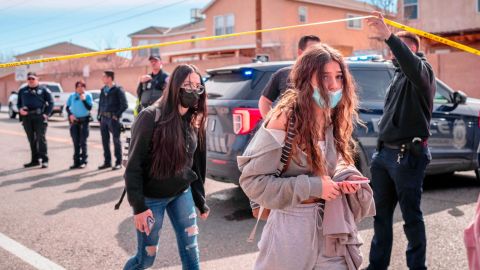 Police and students are seen after a fatal shooting near an Albuquerque high school Friday.