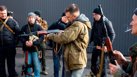 Members of Ukraine's Territorial Defense Force in Kyiv prep their weapons to defend themselves against Russian forces on February 26. 