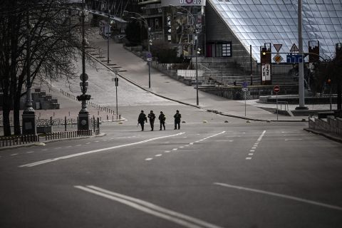 Ukrainian forces patrol mostly empty streets in Kyiv on February 27. Mayor Vitali Klitschko extended a citywide curfew.