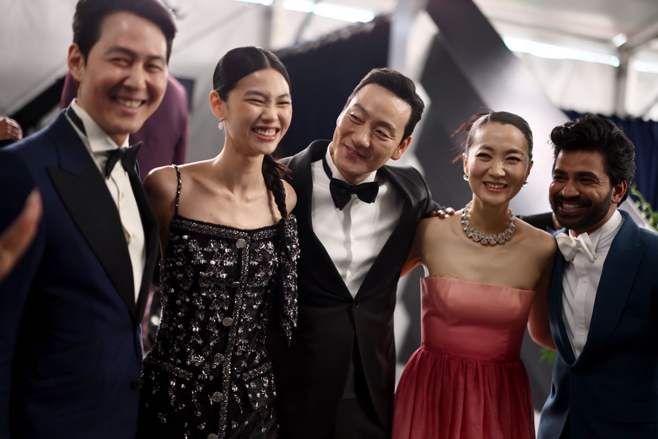 From left, "Squid Game" actors Lee Jung-jae, Jung Ho-yeon, Park Hae-soo, Kim Joo-ryoung and Anupam Tripathi pose for a photo before the show.